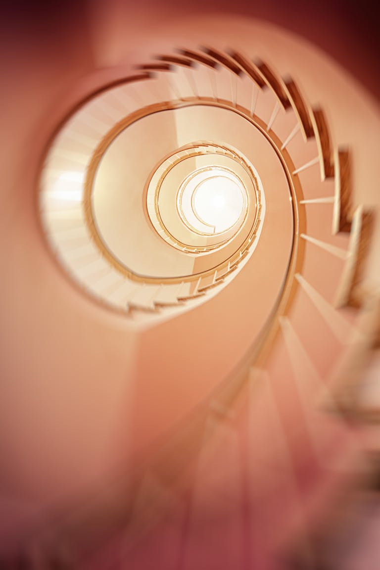 A mesmerizing spiral staircase captured in a soft blur, creating a dreamy effect.